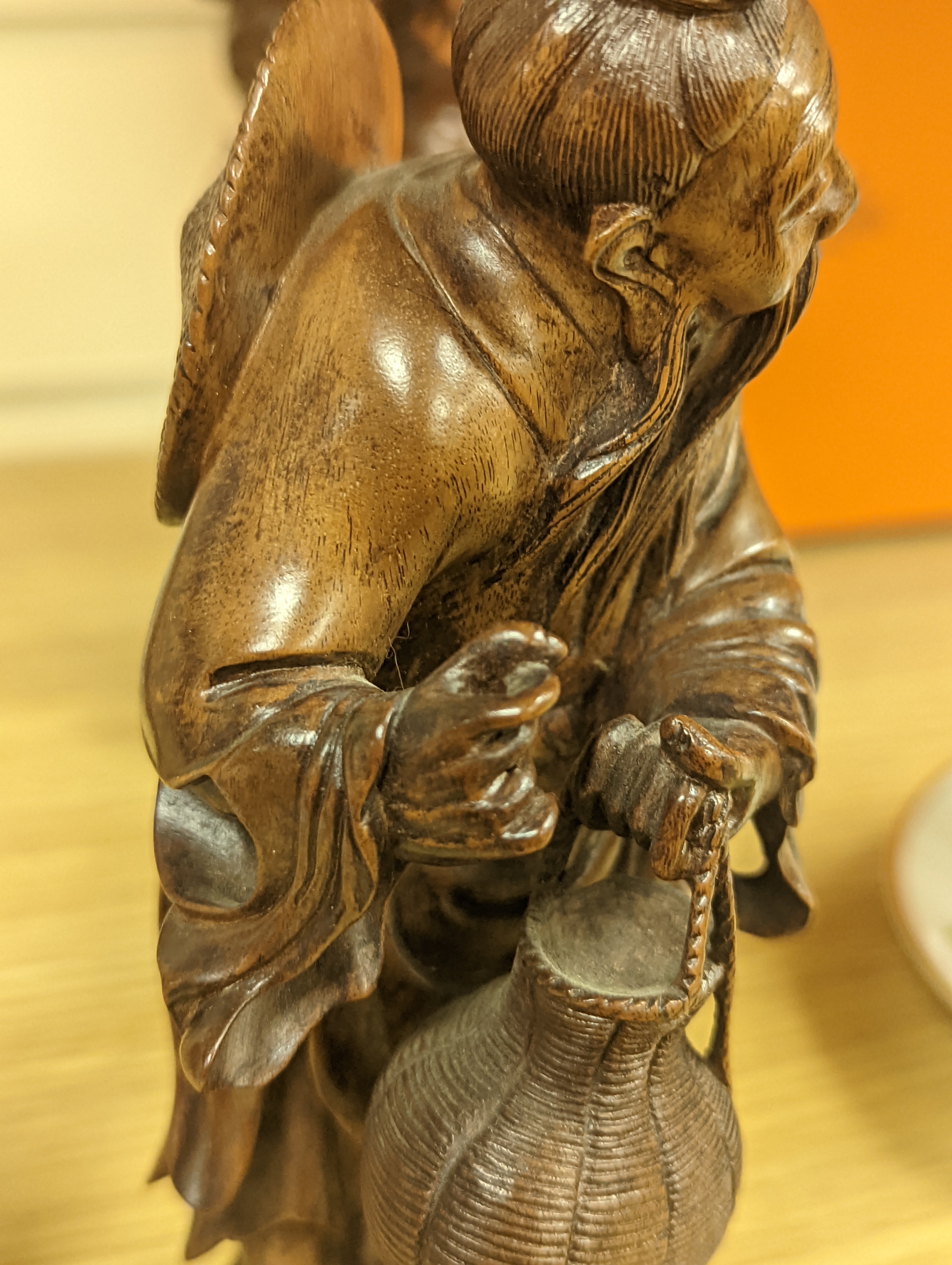 Two Chinese hardwood figures of a fisherman and a old man holding peaches 16cm